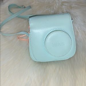 A  Instax camera with his blue suitcase 💙